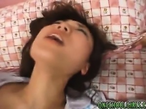 Japanese girl fingers wet pussy in close up before a harsh b