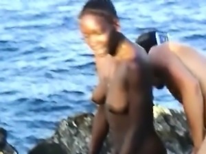 Black chick sucks white cocks and gets fucked on beach