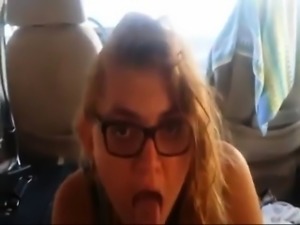 Slut with glasses sucks on a large cock about the back-seat