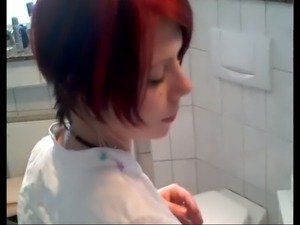 This short haired redhead is not shy peeing in front of the camera