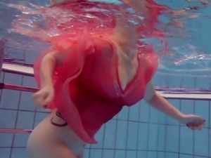 Fire red haired girl Katrin Privsem swimming naked in a pool