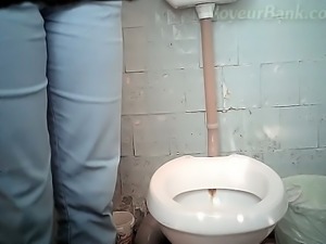 Blonde chick in blue jeans and red panties pisses in the toilet