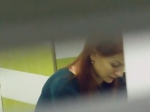 Beautiful redhead stranger girl filmed in the public restroom