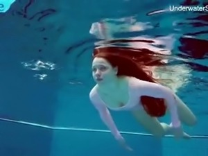 Long haired Simonna is ready to expose her natural pale tits underwater