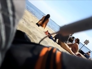 Beach voyeur finds sexy babes getting naked under the sun